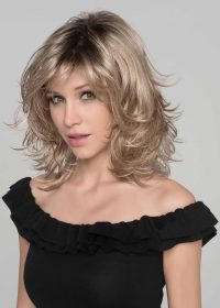 The Ocean wig by Ellen Wille is a beautiful mid-length style wig with light waves. It is shown in sandy blonde rooted.