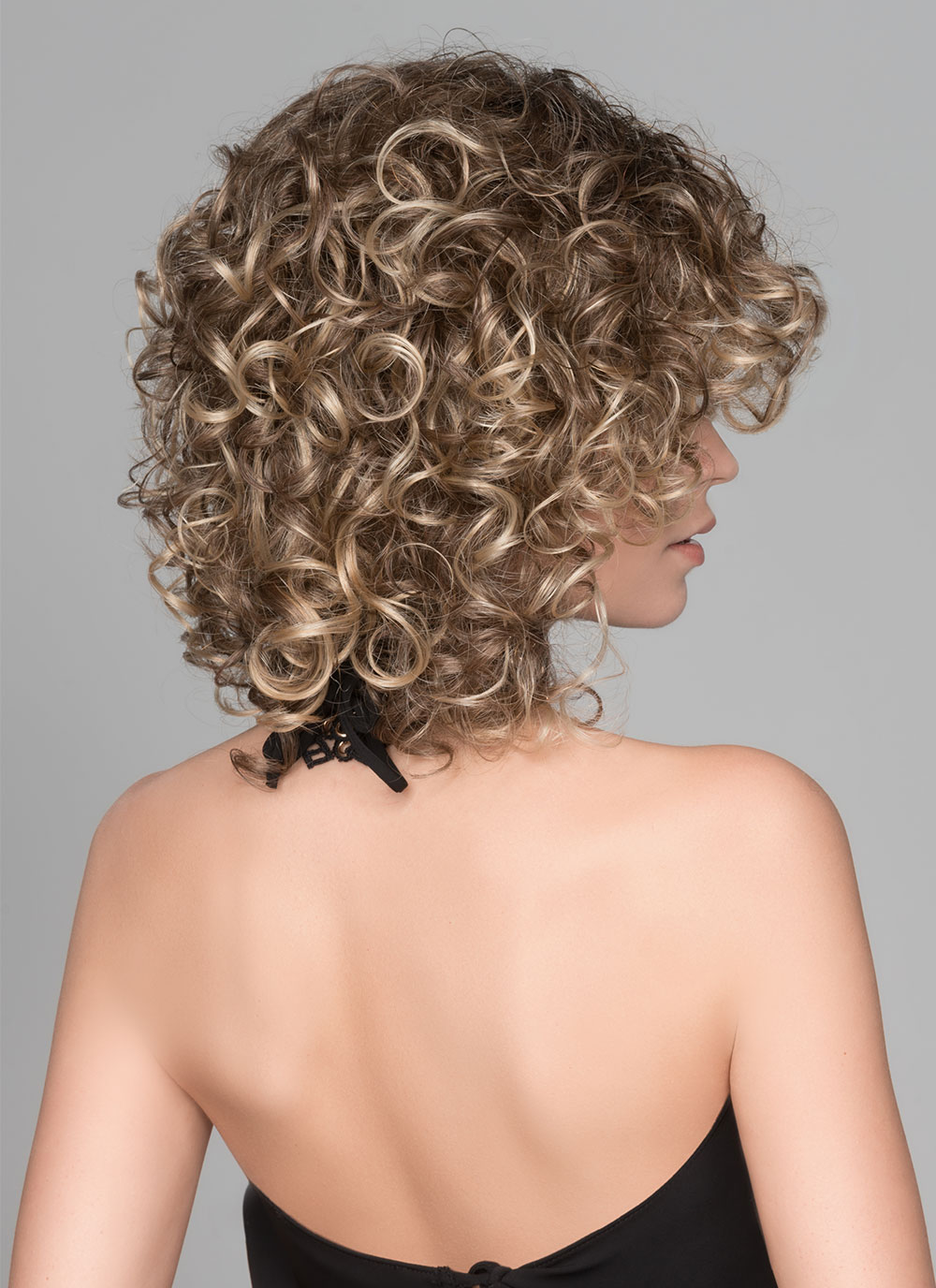 Jamila Plus | The ringlet curls fall just above the shoulders in the back and frame the face in the front.